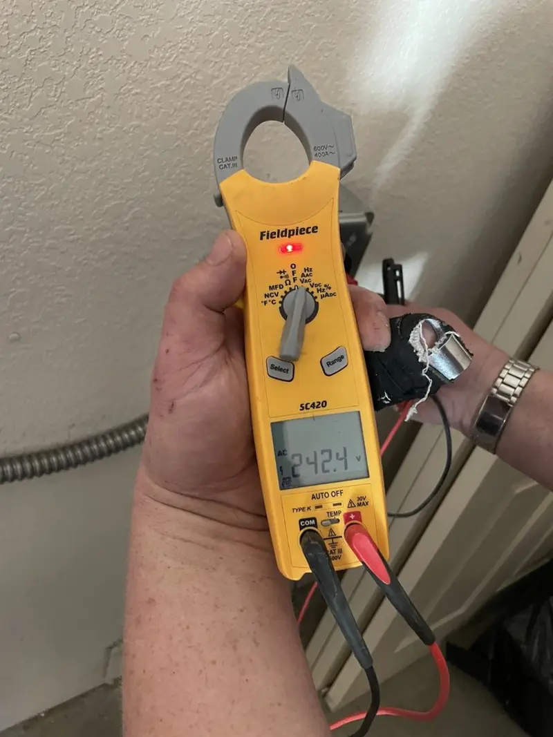 Voltage testing with clamp meter during Whole House Surge Protector in Egg Harbor